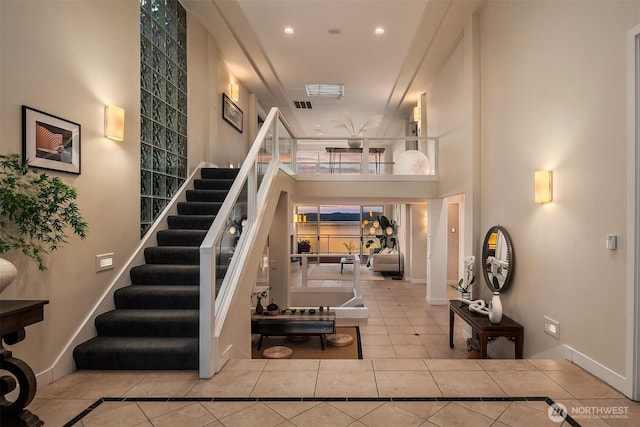 stairs with tile patterned flooring, inlaid floor details, recessed lighting, and baseboards