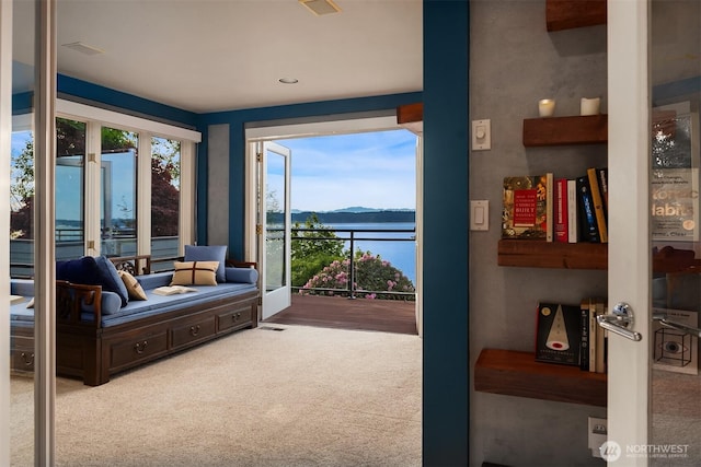 living area with a mountain view and carpet