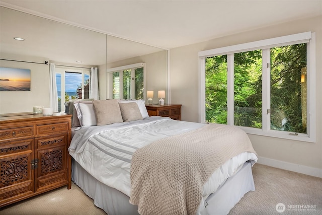 bedroom featuring light colored carpet, baseboards, and recessed lighting