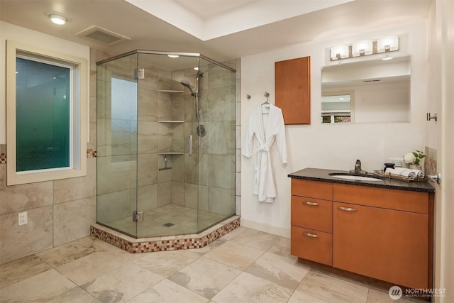 bathroom featuring a shower stall and vanity