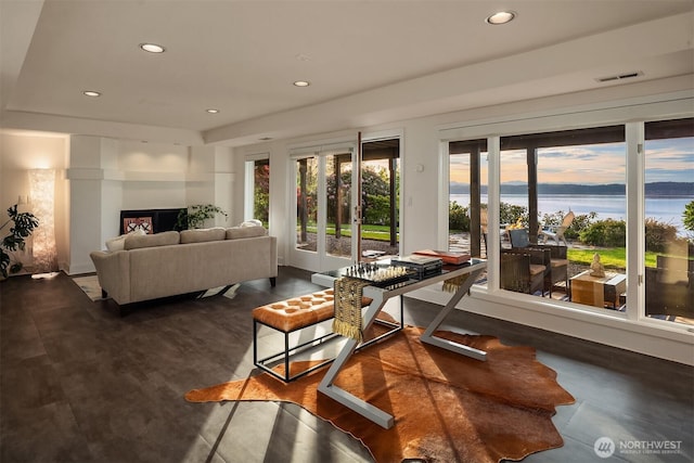 living room featuring recessed lighting and a water view