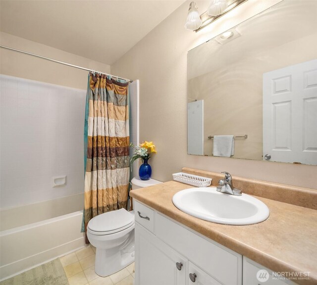 full bath with toilet, vanity, tile patterned flooring, and shower / bath combo