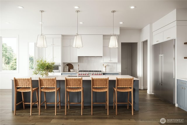 kitchen featuring dark wood-style flooring, white cabinetry, light countertops, recessed lighting, and high end fridge