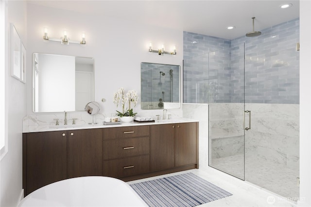 full bathroom with double vanity, a shower stall, a sink, and a freestanding bath