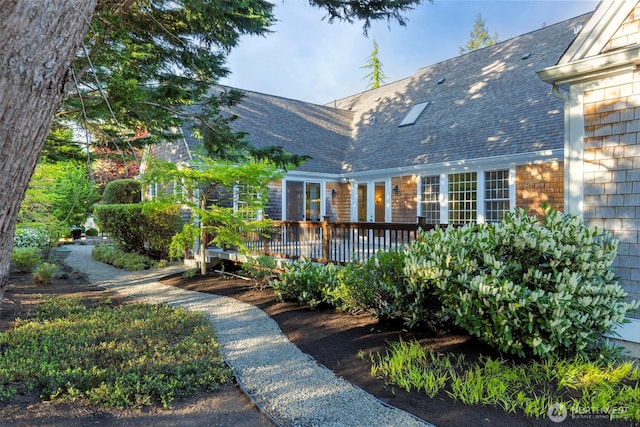 11281 Fieldstone Ln NE, Bainbridge Island, WA 98110 - view of front of home with a wooden deck and roof with shingles