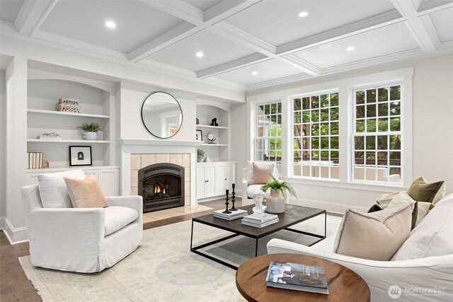 11281 Fieldstone Ln NE, Bainbridge Island, WA 98110 - living area featuring baseboards, wood finished floors, a tiled fireplace, coffered ceiling, and crown molding