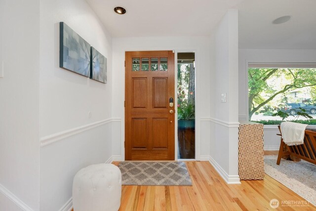 entryway with light wood-style floors, baseboards, and recessed lighting