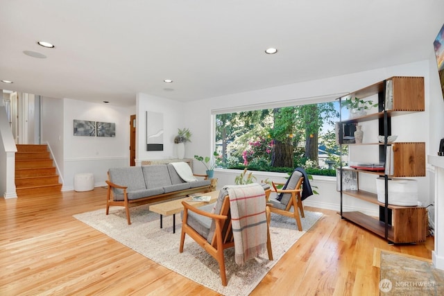 living room featuring light wood-style floors, stairway, recessed lighting, and baseboards