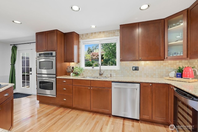 kitchen with appliances with stainless steel finishes, wine cooler, a sink, decorative backsplash, and recessed lighting
