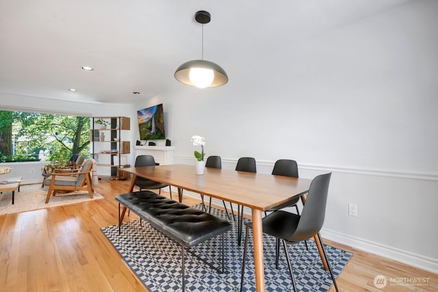 dining room with light wood-type flooring, baseboards, and recessed lighting
