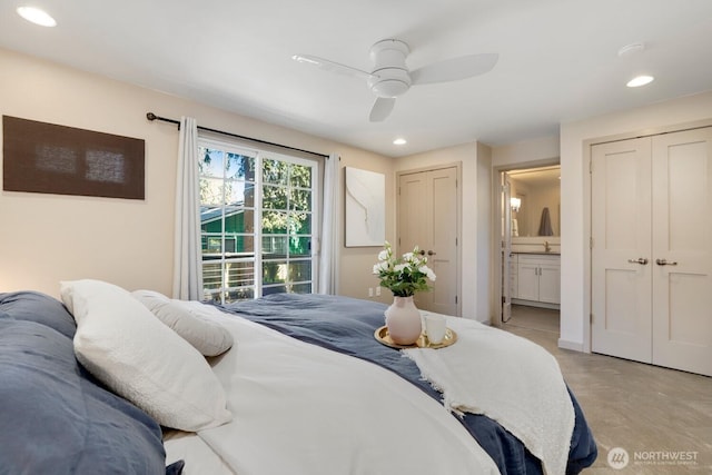 bedroom featuring two closets, recessed lighting, ensuite bath, and a ceiling fan