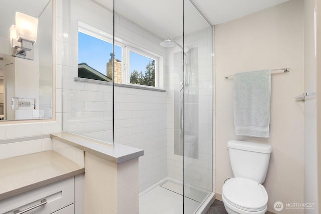 bathroom with a walk in shower, toilet, and vanity