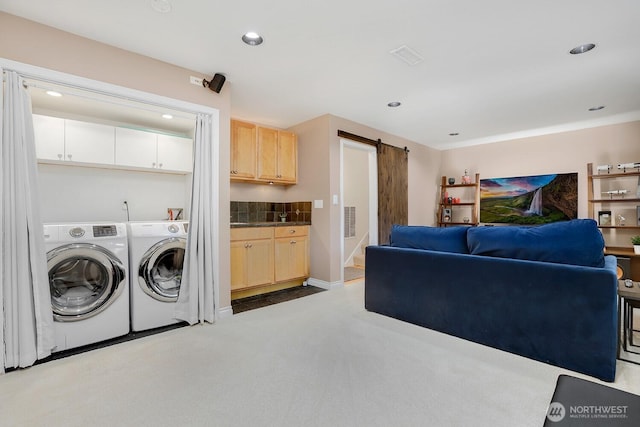 laundry area with washer and dryer, a barn door, recessed lighting, and carpet