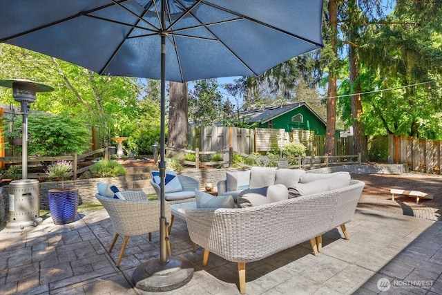 view of patio with an outdoor living space and a fenced backyard