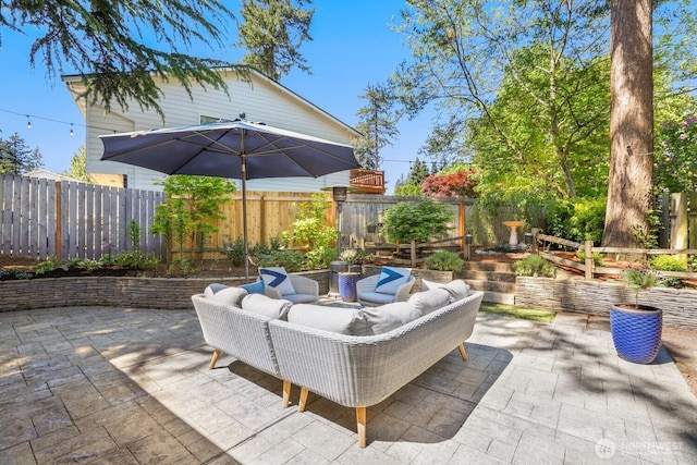 view of patio / terrace with an outdoor hangout area and fence