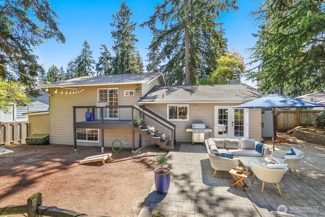 back of property with fence, a patio, outdoor lounge area, stairway, and a chimney