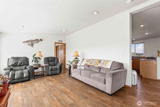 living area featuring recessed lighting, visible vents, and wood finished floors