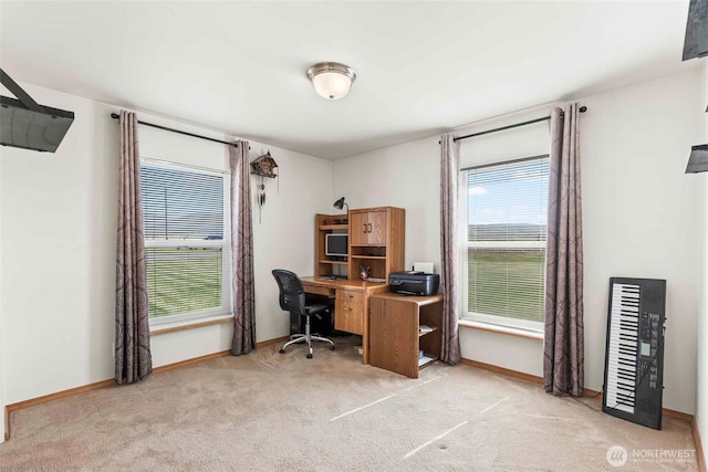 office space featuring baseboards and light colored carpet