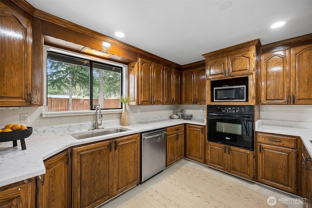 kitchen featuring a sink, appliances with stainless steel finishes, backsplash, and brown cabinets