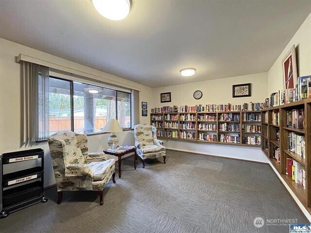 240 Parkwood Blvd, Sequim, WA 98382 - living area featuring wall of books and carpet floors