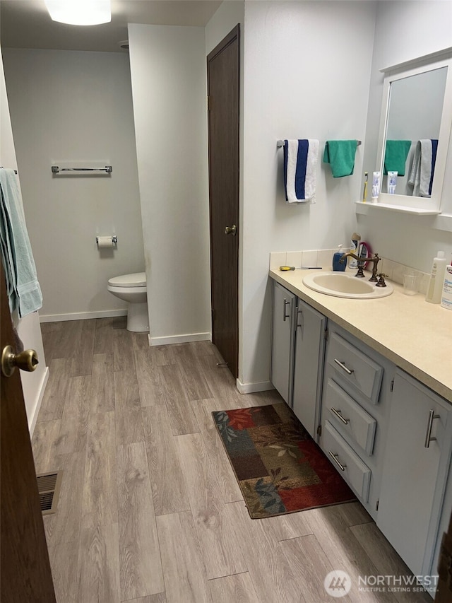240 Parkwood Blvd, Sequim, WA 98382 - bathroom featuring wood finished floors, vanity, toilet, and baseboards