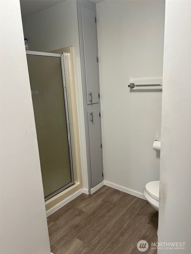 240 Parkwood Blvd, Sequim, WA 98382 - bathroom with wood finished floors, a shower stall, toilet, and baseboards