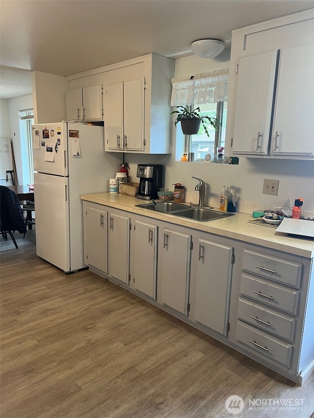 240 Parkwood Blvd, Sequim, WA 98382 - kitchen with a sink, light countertops, light wood-type flooring, and freestanding refrigerator