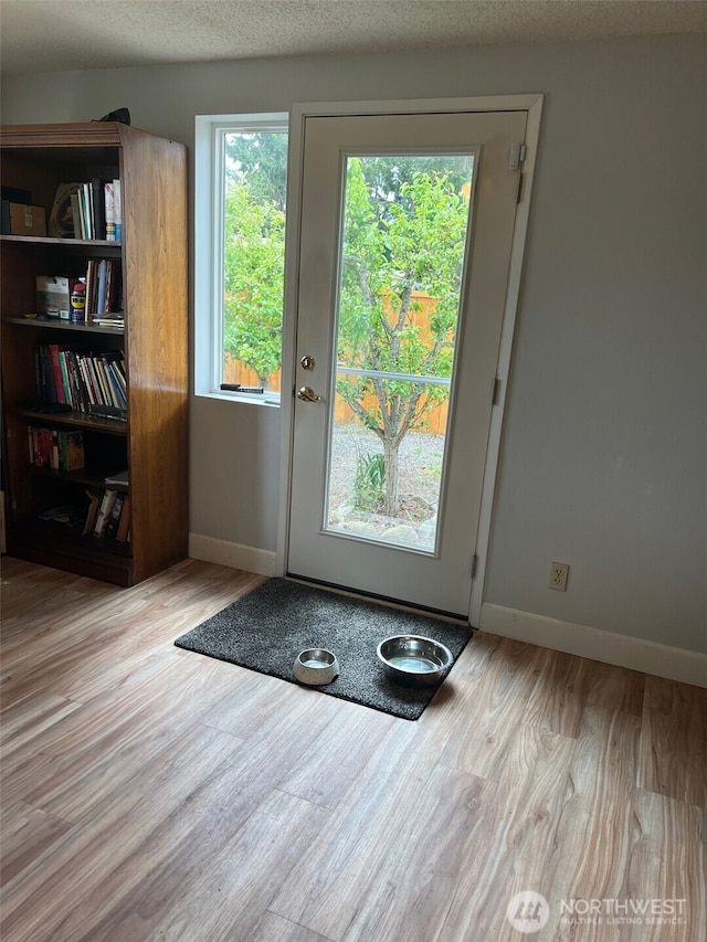 240 Parkwood Blvd, Sequim, WA 98382 - entryway with wood finished floors, baseboards, and a textured ceiling