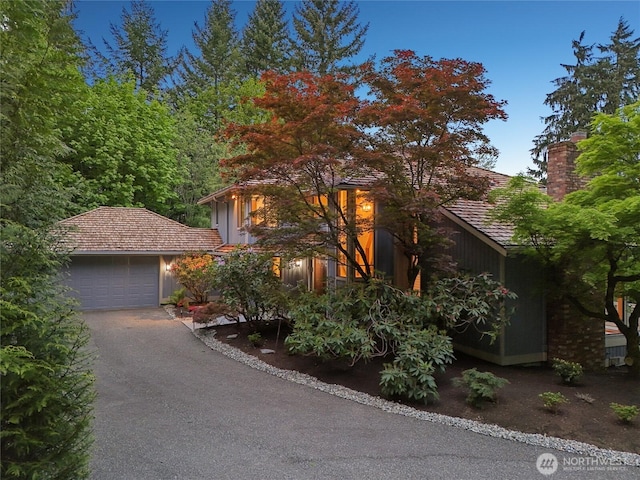 14320 2nd Ave NE, Marysville, WA 98271 - obstructed view of property with driveway, a chimney, and a garage