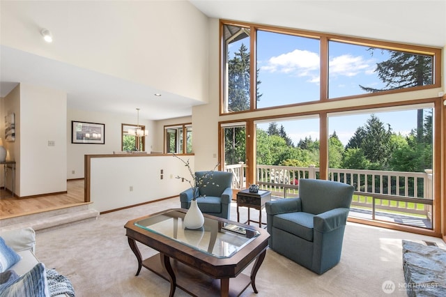 14320 2nd Ave NE, Marysville, WA 98271 - living room with light colored carpet, a towering ceiling, and baseboards