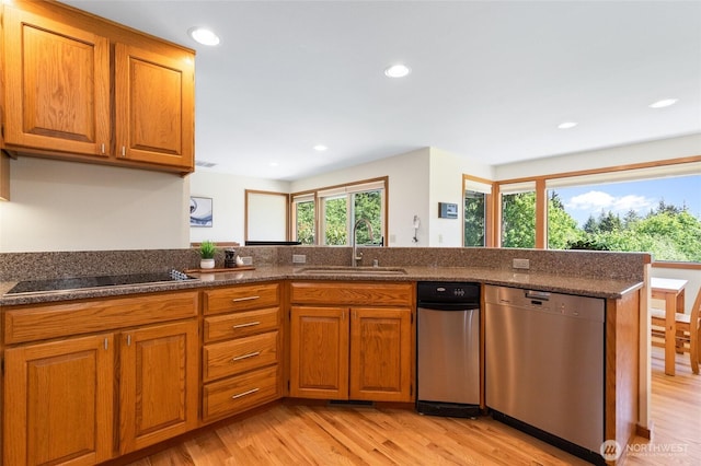 14320 2nd Ave NE, Marysville, WA 98271 - kitchen with stainless steel dishwasher, a sink, black electric cooktop, light wood-style flooring, and brown cabinetry
