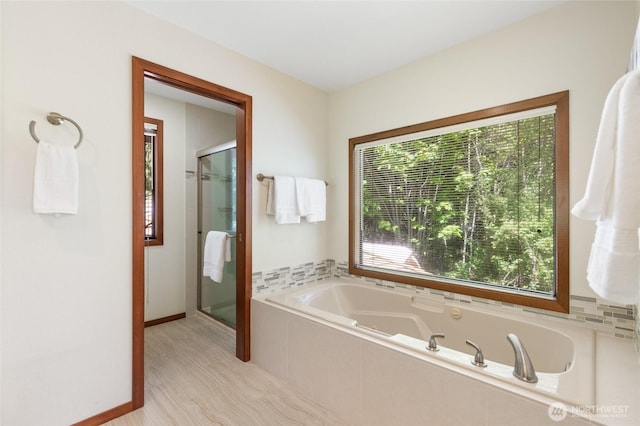 14320 2nd Ave NE, Marysville, WA 98271 - full bath featuring a garden tub, a shower stall, and baseboards