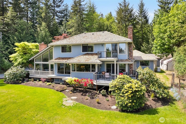 14320 2nd Ave NE, Marysville, WA 98271 - back of house with a chimney, a sunroom, and a lawn