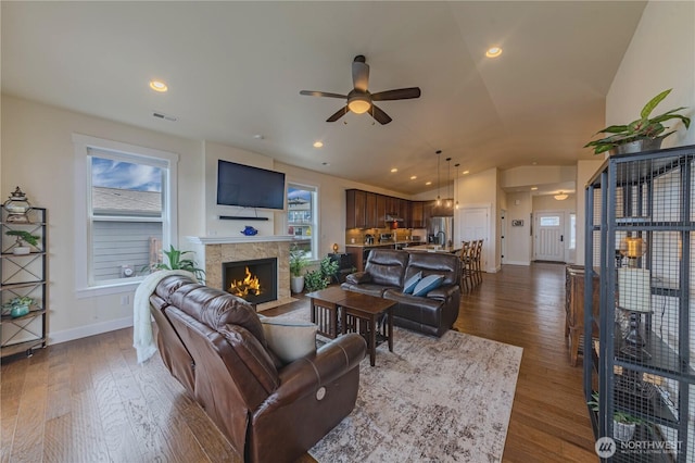 1602 Latitude Cir, Anacortes, WA 98221 - living area with a ceiling fan, a fireplace with flush hearth, dark wood-type flooring, baseboards, and lofted ceiling