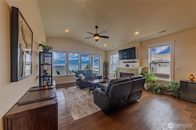 1602 Latitude Cir, Anacortes, WA 98221 - living room with dark wood-type flooring, a ceiling fan, lofted ceiling, a tile fireplace, and recessed lighting