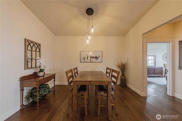1602 Latitude Cir, Anacortes, WA 98221 - dining space featuring dark wood finished floors, baseboards, and lofted ceiling