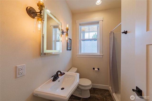 1602 Latitude Cir, Anacortes, WA 98221 - bathroom featuring a sink, toilet, curtained shower, and baseboards