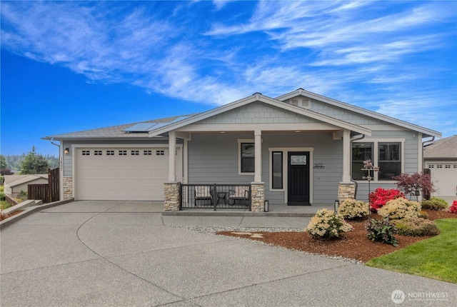 1602 Latitude Cir, Anacortes, WA 98221 - craftsman inspired home with covered porch, concrete driveway, a garage, solar panels, and stone siding