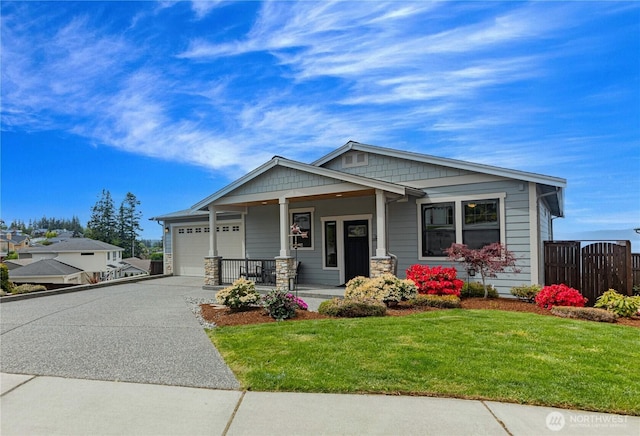 1602 Latitude Cir, Anacortes, WA 98221 - craftsman-style home with covered porch, an attached garage, concrete driveway, and stone siding