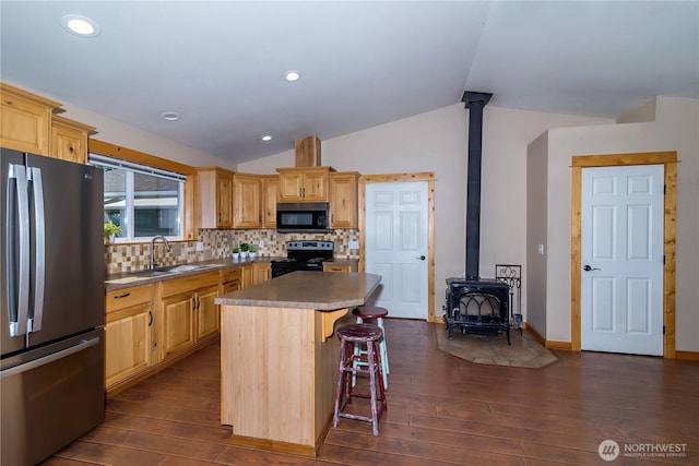 kitchen featuring light brown cabinetry, dark wood finished floors, a sink, and black appliances
