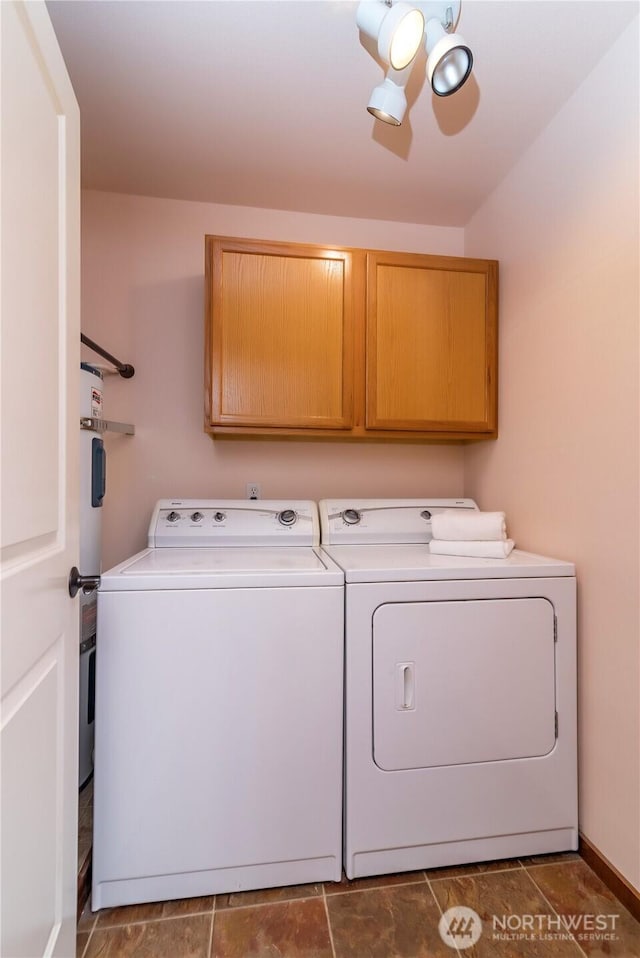 washroom featuring cabinet space and independent washer and dryer