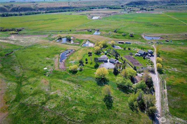 drone / aerial view featuring a water view and a rural view