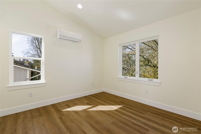 9253 6th Ave NW, Seattle, WA 98117 - spare room with baseboards, an AC wall unit, wood finished floors, and lofted ceiling