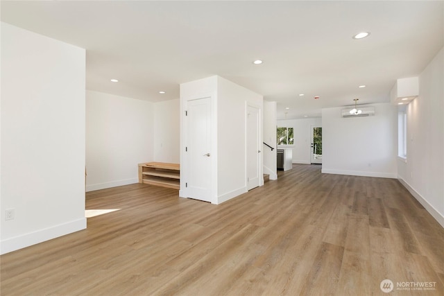 9253 6th Ave NW, Seattle, WA 98117 - empty room featuring baseboards, a wall unit AC, recessed lighting, and light wood-style flooring