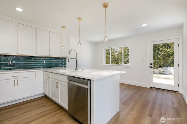 9253 6th Ave NW, Seattle, WA 98117 - kitchen featuring light wood-type flooring, a sink, dishwasher, and light countertops