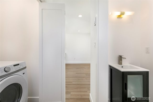 9253 6th Ave NW, Seattle, WA 98117 - laundry area with a sink, washer / clothes dryer, recessed lighting, baseboards, and light wood-type flooring
