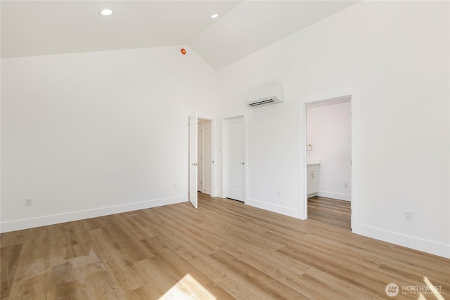 9253 6th Ave NW, Seattle, WA 98117 - empty room with high vaulted ceiling, a wall unit AC, baseboards, and light wood finished floors