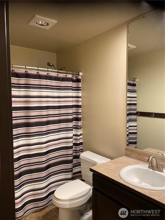 bathroom with vanity, tile patterned flooring, toilet, and a shower with shower curtain