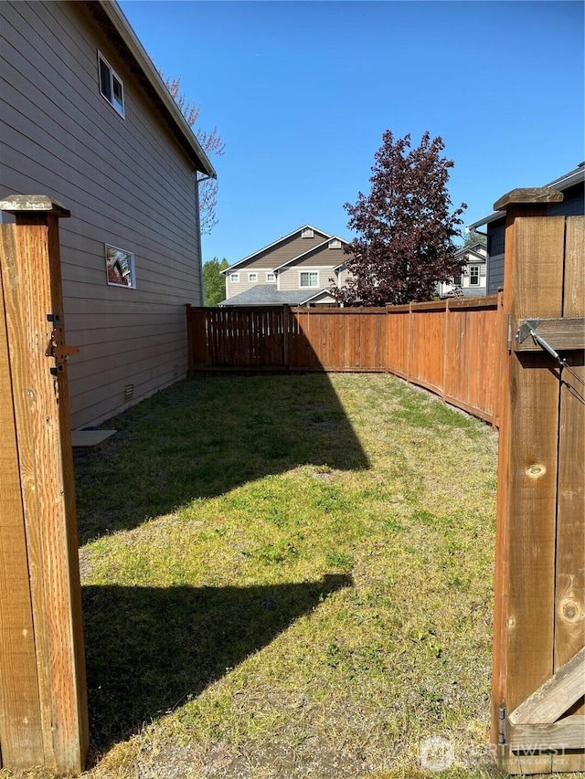 view of yard with a fenced backyard