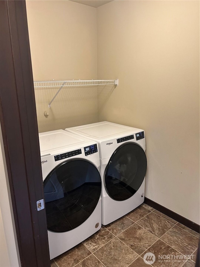 laundry room with washing machine and clothes dryer, laundry area, and baseboards